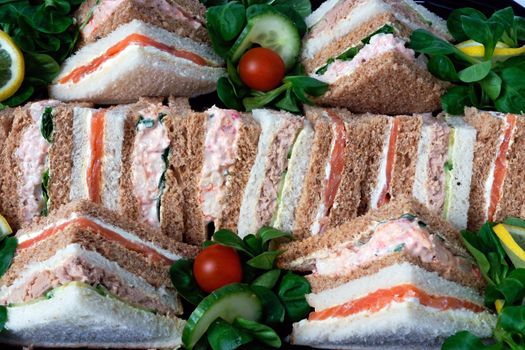 A group of sandwiches cut into triangles for a business lunch