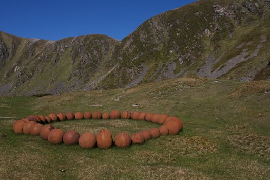 Numerous rusted spheres making a giant necklace. Taken on Andøya, Norway.