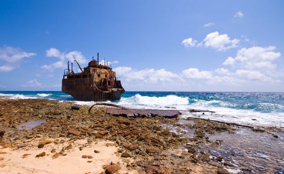 rusty caribbean shipwreck washing ashore 
