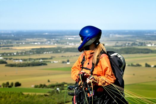 Paraglider ready to jump and waiting for the wind