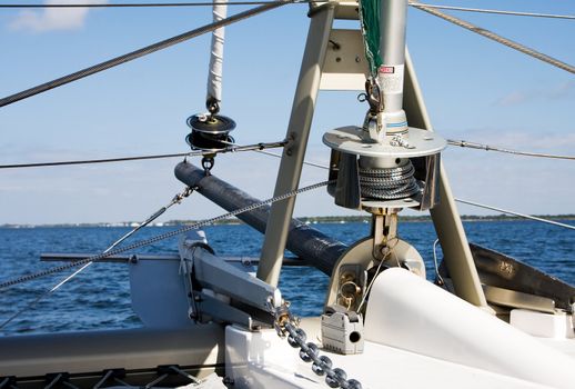 The bow of a Catamaran as seen from the ship itself focusing on the spools that control the front sails