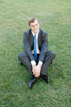A business man sitting in the park relaxing