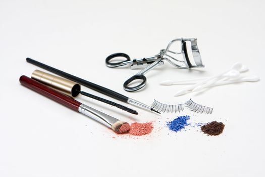Makeup set for the eyes with eyeshadows, brush, mascara, curler, q-tips and lashes, isolated