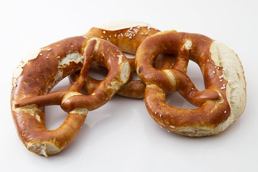 three german traditional pretzels on white background
