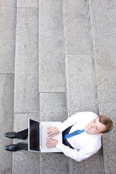 Business man sitting on stairs outdoor