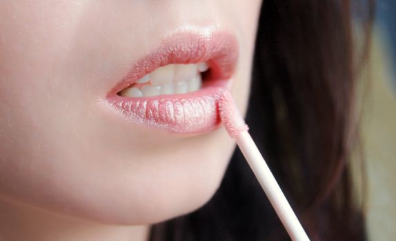 beautiful woman's lipstick applying