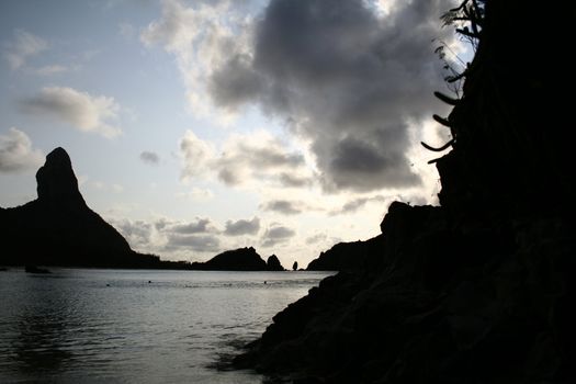 The silhouette of rock in Fernando de Noronha, at sun down.