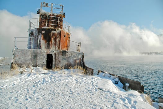 Old a river vessel. A fog. The river Yenisei in the winter.