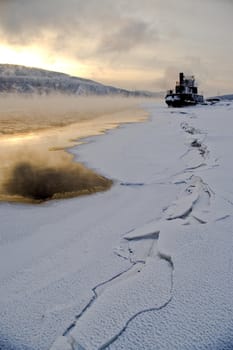 
The river. A winter landscape. Ice, water. A river coast.