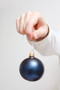 A man holding a christmas ornament