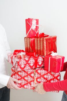 A man giving a christmas present to a woman