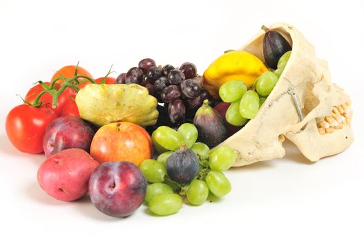 Side view of human skull overflowing with fruits and vegetables.