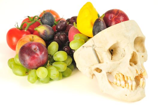 A human skull overflowing with fruits and vegetables, like a horn of plenty.