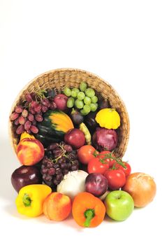 A rich bounty of autumn harvest foods spilling from a basket