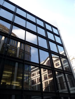 A set of reflective windows on an office building.