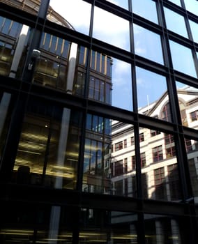 A set of reflective windows on an office building.