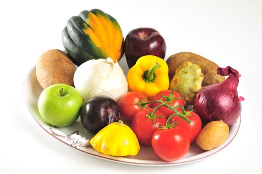 White porcelain platter full of autumn fruits and vegetables