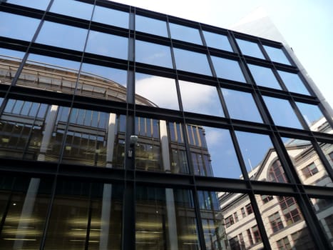 A set of reflective windows on an office building.
