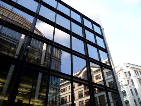 A set of reflective windows on an office building.
