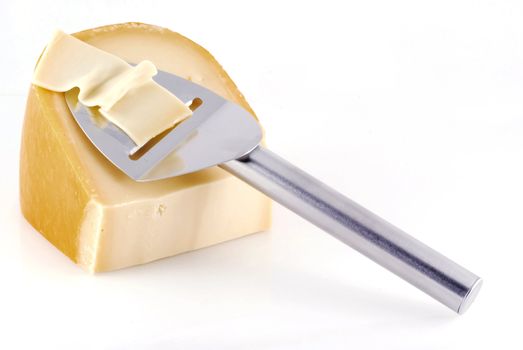 Cheese with slicer isolated on a white background.