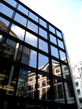 A set of reflective windows on an office building.