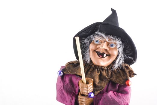 Portrait of a witch doll with copyspace; isolated on white.