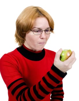 The girl in a red sweater eats an apple
