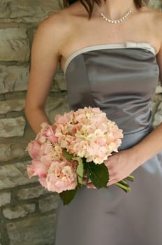 A chic image of a bridesmaid with her bouquet
