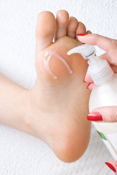 pedicure, applying the cream to soften and moisturize