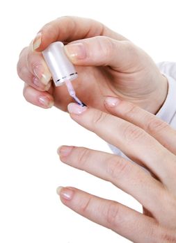 Female hands nails painting with a varnish