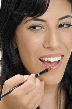 smiling lady putting lipstick