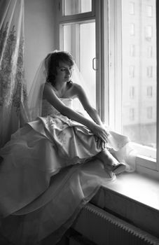 The beautiful thoughtful bride in an interior