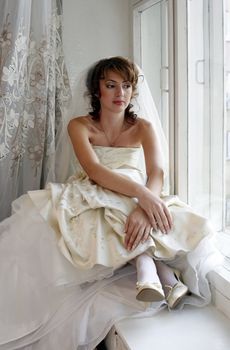 The beautiful thoughtful bride in an interior