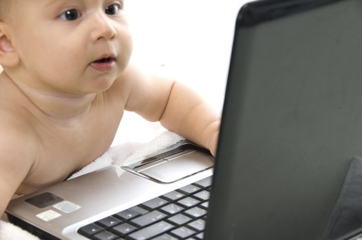 young child interested with laptop on an isolated white background