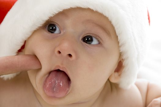 cute young baby wearing santa cap against white background