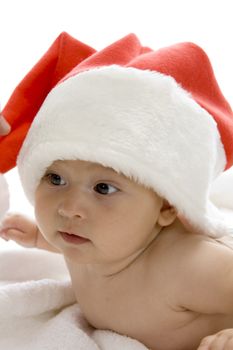 cute young baby wearing santa cap against white background