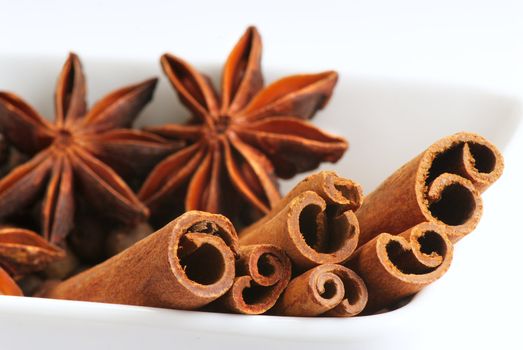 Star anise and cinnamon sticks, on a porcelain ware