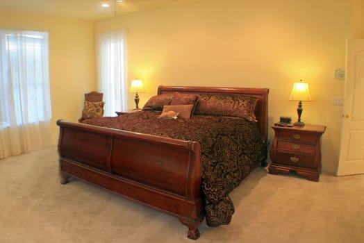 A Master Bedroom with a sleigh bed.