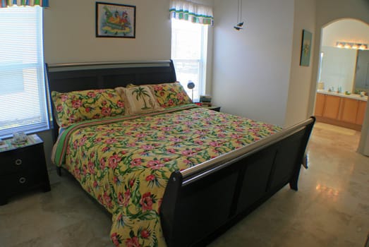 A tropical themed bedroom, interior shot of a home.