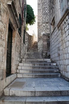 A European stairway leading up a hill off a street