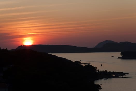 A golden sunset casting its rays over a local harbor