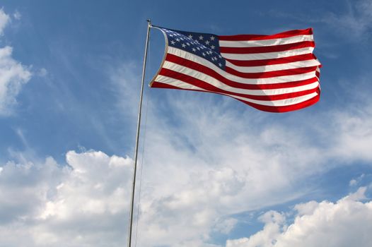 American Flag flowing in the blue sky