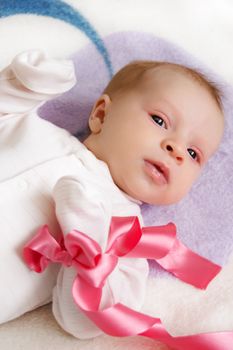 Cute baby girl with pink ribbon