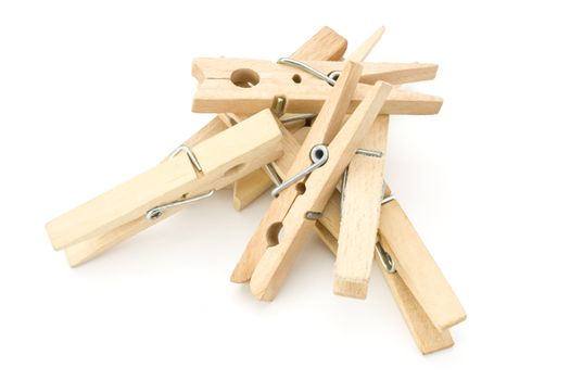 a heap of wooden clothespins on white background