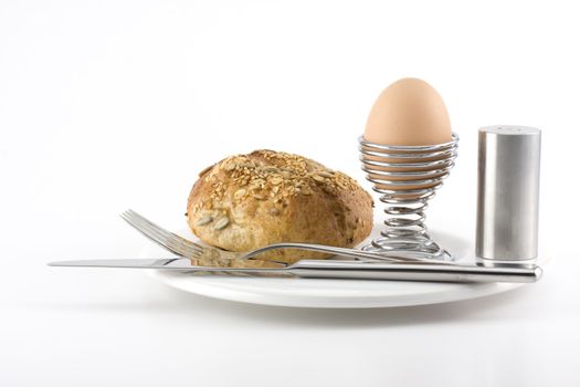 bun, egg, cutlery and a white plate