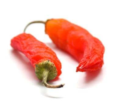 Red peppers on a white background. Isolation, shallow DOF