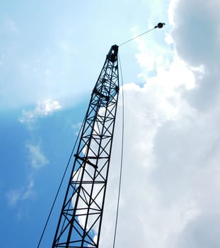A crane lifting a ball hig in the air