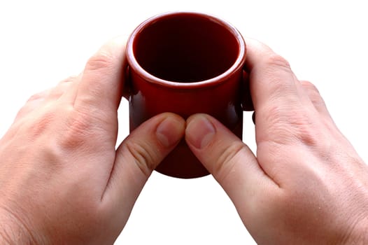 Pottery cup for tea or coffee in man's hands on isolated background.