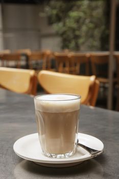 Cafe Latte Coffee on a Saucer with Teaspoon