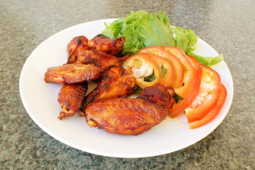 Chicken Wings on a White Plate with Vegetables